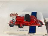 a red toy car sitting on top of a box