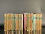 several books are stacked on top of each other on a table