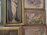many framed pictures on the wall of a room