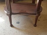 a wooden table with a glass top on the floor