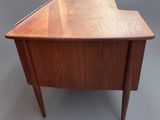 an image of a small wooden desk with a curved top
