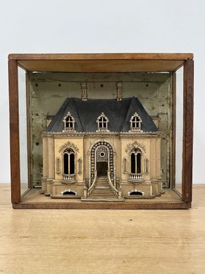 a small model of a house in a wooden case