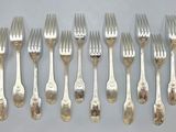 six forks and six spoons are lined up on a table