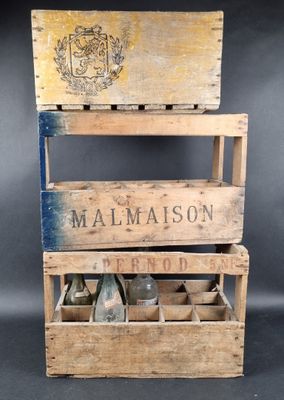 an old wooden crate with a bottle of malmaison on top