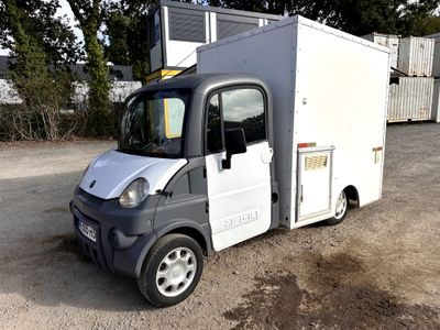 une photo d'un petit camion garé sur un parking