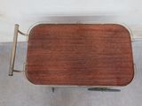a small wooden table with a metal frame on it