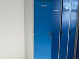 two blue lockers in the corner of a room