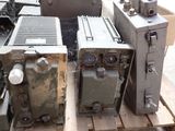 many old appliances sitting on a pallet in a warehouse