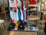 a metal rack with clothes on it in a room