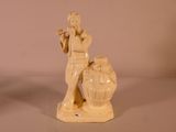 a figurine of a man with a flute in his hand