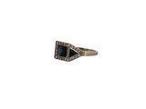 a close up of a ring on a white background with a blue stone
