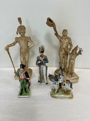 cinq figurines représentant des soldats et un chien posées sur une table