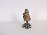 bronze figurine of a little girl with a bag on a marble base