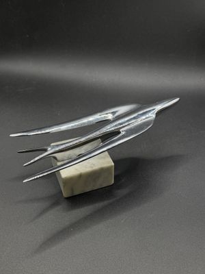 three forks and a block of cheese on a table