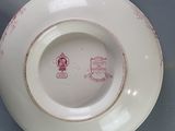 a white plate with a red design on it