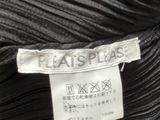 the label of a black dress with pleas on a hanger