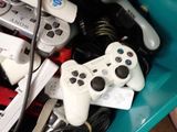 many video game controllers sitting in a blue container