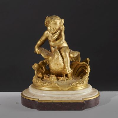 an image of a gold statue of a child on a rock