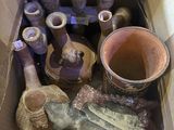 une boîte remplie de vases et d'autres objets qui s'y trouvent