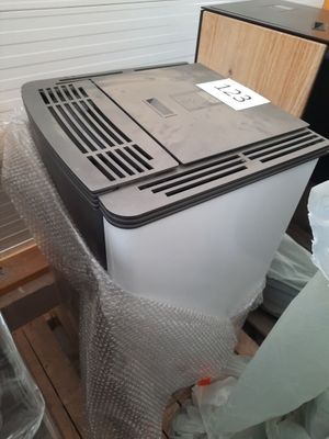 a small air conditioner sitting on a pallet in a room