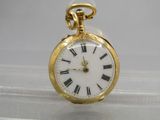 a gold pocket watch with roman numerals on it