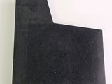 a close up of a piece of black paper sitting on top of a white table