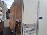 a truck that is parked in a lot with it ' s door open