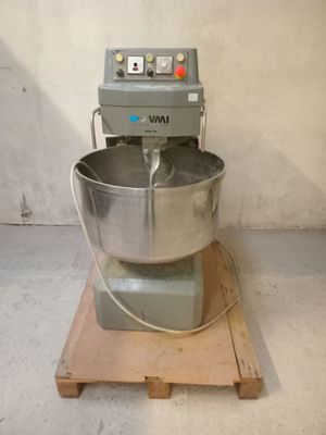 a mixer sitting on a pallet in a room
