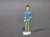 a small figurine of a man in a blue shirt and green pants