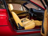 a red car with a yellow seat in the back of it