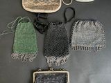a group of purses sitting on top of a table next to each other