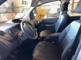 the interior of a small car with a steering wheel and dashboard