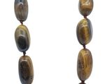a close up of a necklace with tiger eye beads on a white background