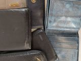 many different types of leather wallets sitting on a table