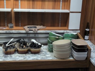 many bowls and pans on the counter in the kitchen