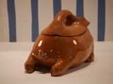 a ceramic pig that is sitting on a table