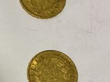 three gold coins sitting on a table next to each other