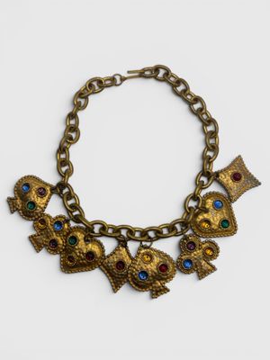 a close up of a gold bracelet with owls on it