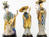 three chinese figurines of women with musical instruments and hats