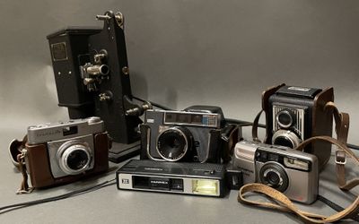 five old cameras sitting next to each other on a table