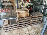 a pile of wooden pallets sitting outside of a store