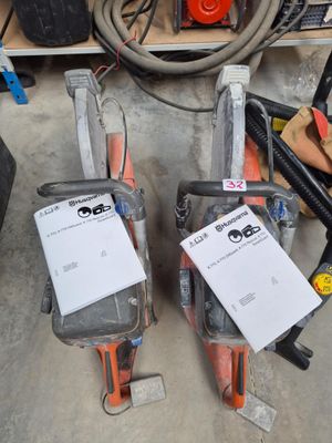 two chainsaws that are sitting next to each other