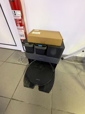 a box sitting on top of a toilet in a room