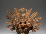 bronze sculpture of a sunflower with a bird on top of it