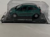 a small green car in a clear case