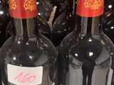 bottles of wine are lined up on a shelf in a store