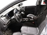 the interior of a silver car with black seats and a steering wheel