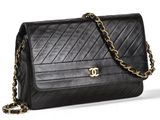a black chanel bag with a gold chain strap