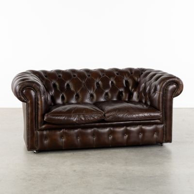une photo d'un canapé Chesterfield en cuir marron dans une pièce