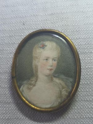 portrait of a woman in a white dress with a flower in her hair